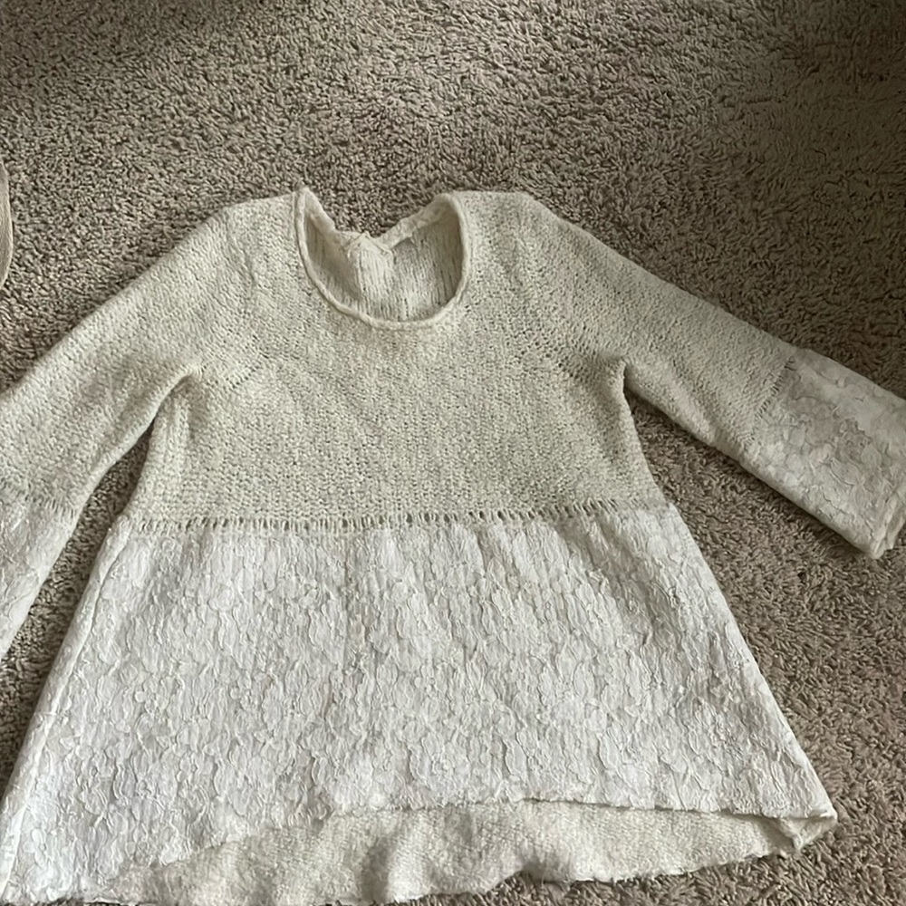 Peplum style knit sweater with lace detail
